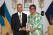 Tellis Bethel presents a copy of his book to the Governor General
